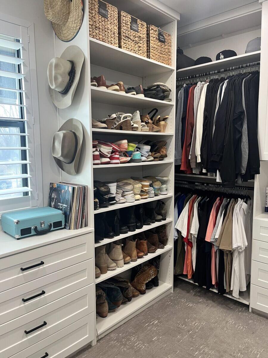 Master closet corner after organizing with shoes and hats