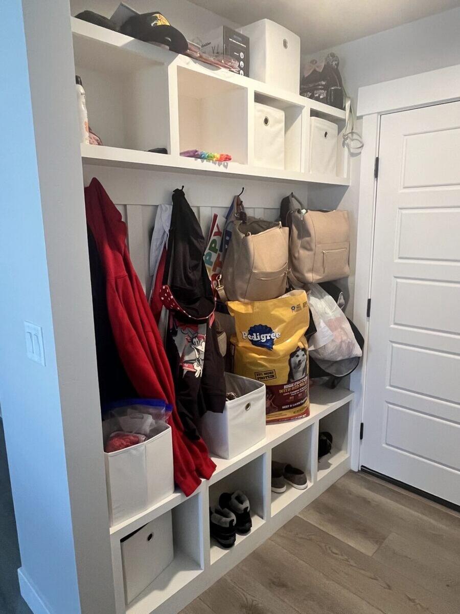 Mudroom before organizing with cluttered cubbies