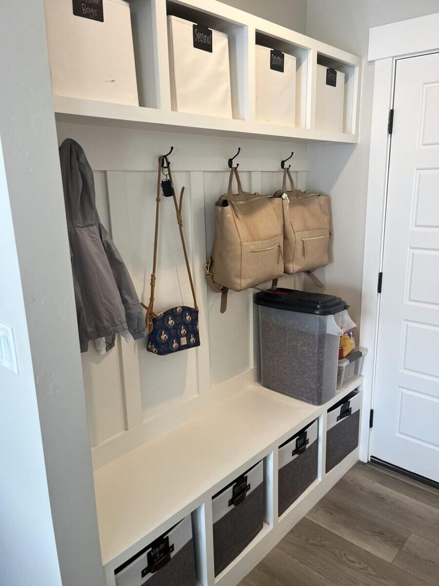 Mudroom after organizing with matching bins and hooks