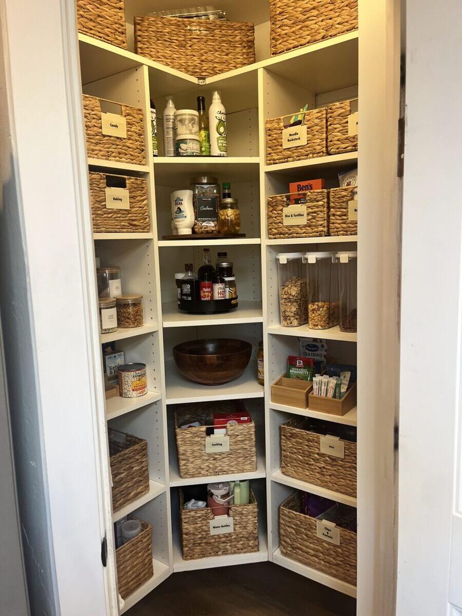 Pantry after organizing with wicker baskets and labels