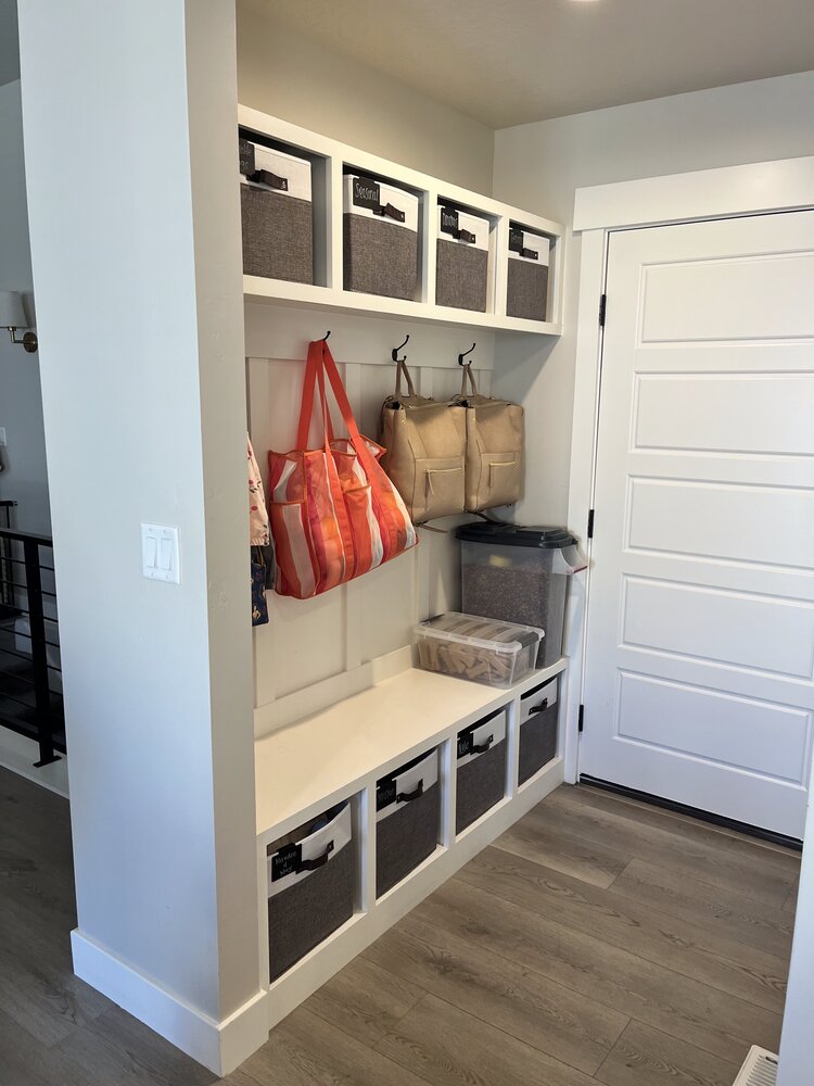 Organized mudroom with baskets and hooks